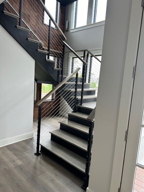 A staircase in a house with a wire railing