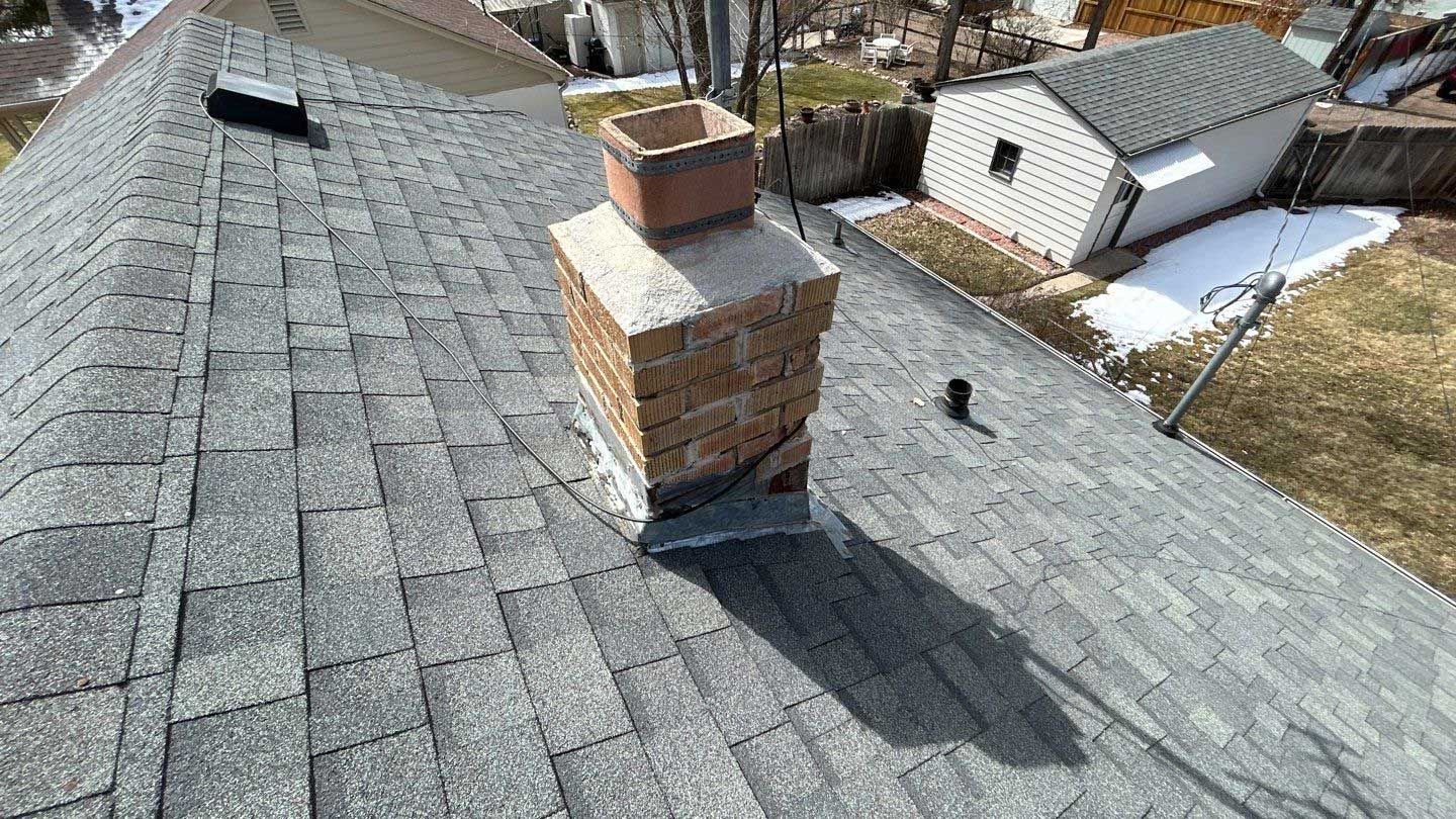 A chimney is on the roof of a house.