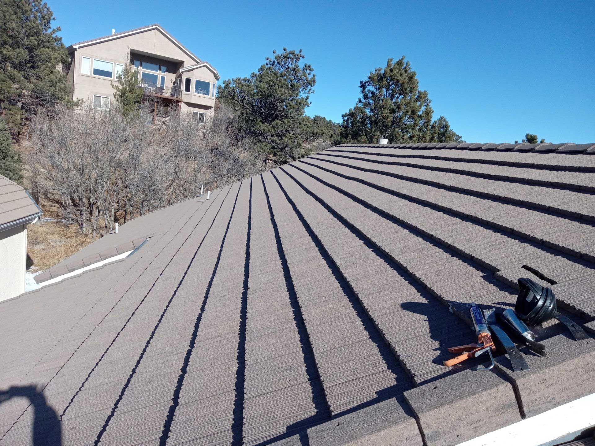 A roof with a camera on it and a house in the background