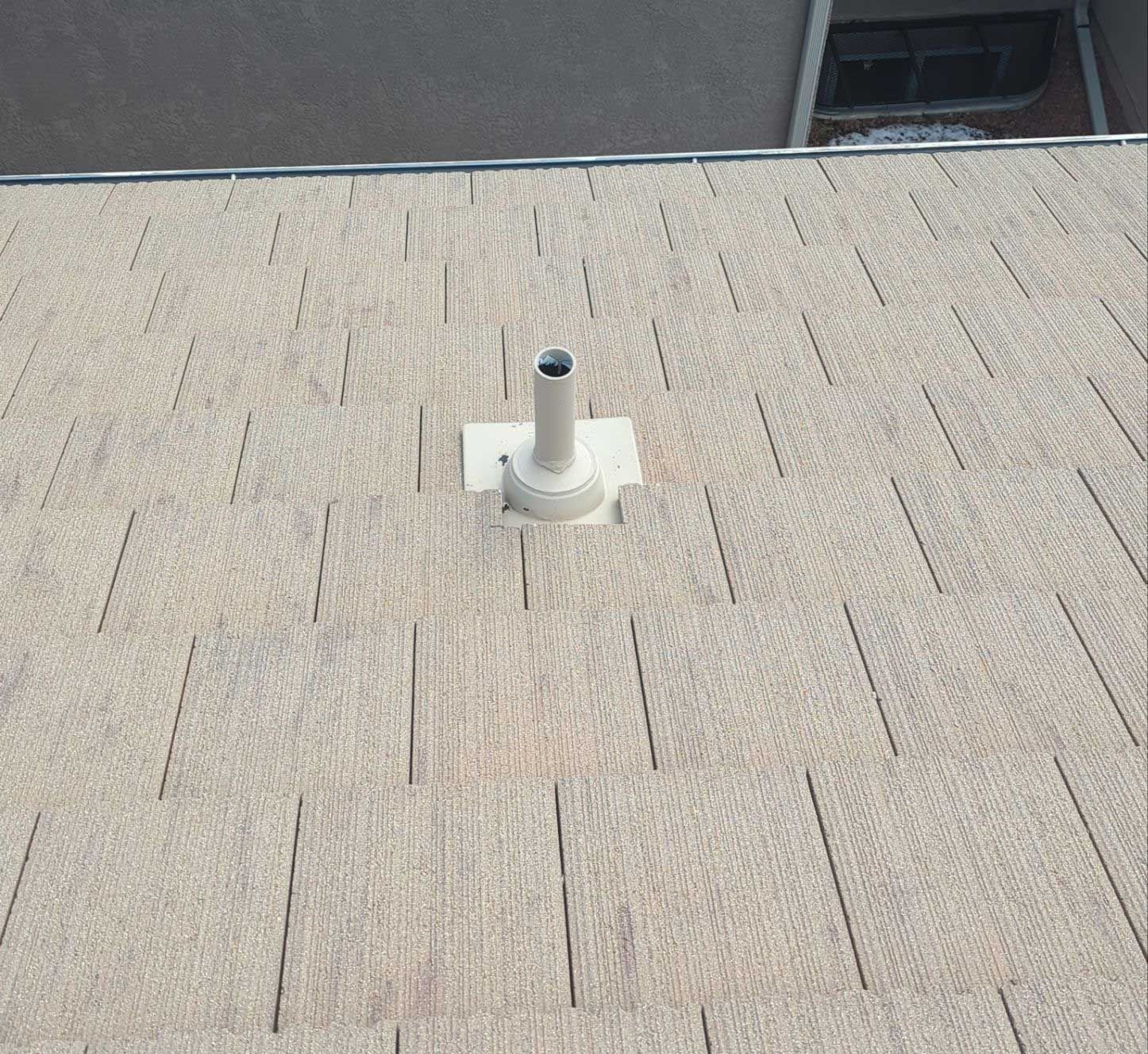 A roof with a chimney on top of it