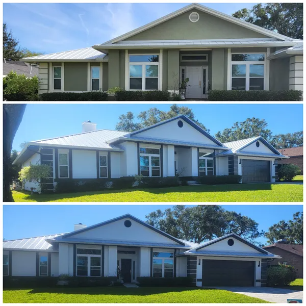 Three houses with light-colored walls and metal roofs, in differing shades of green and white, against a sunny sky.