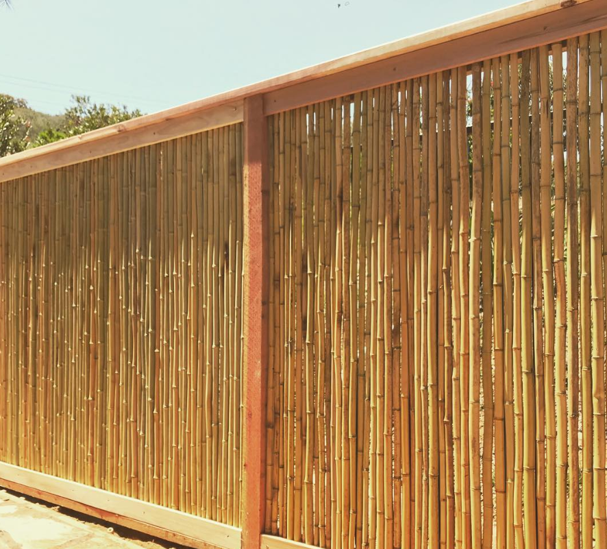 A close up of a bamboo fence with a wooden frame