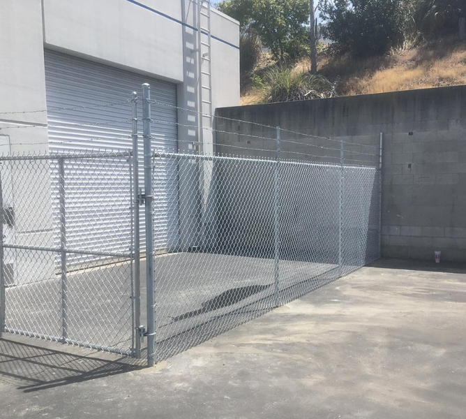 A chain link fence is in front of a building
