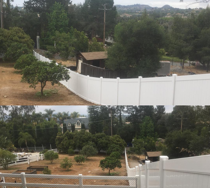 A white fence is surrounded by trees and dirt