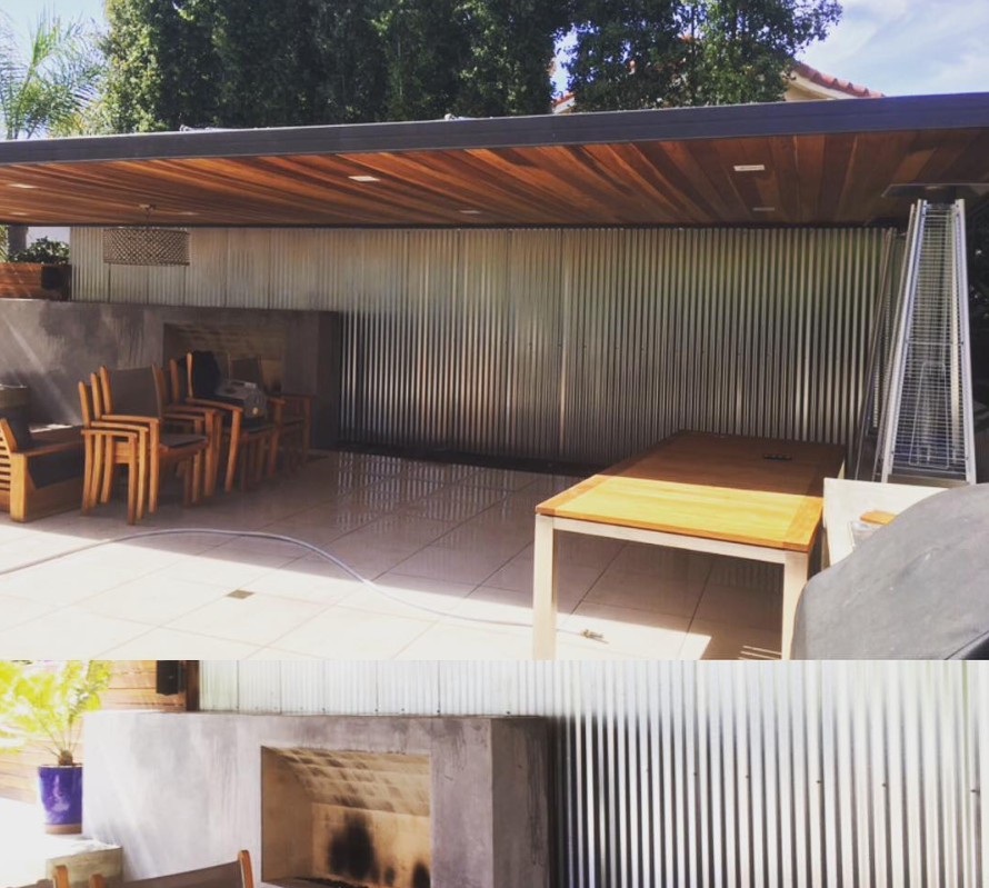 A patio with tables and chairs and a fireplace