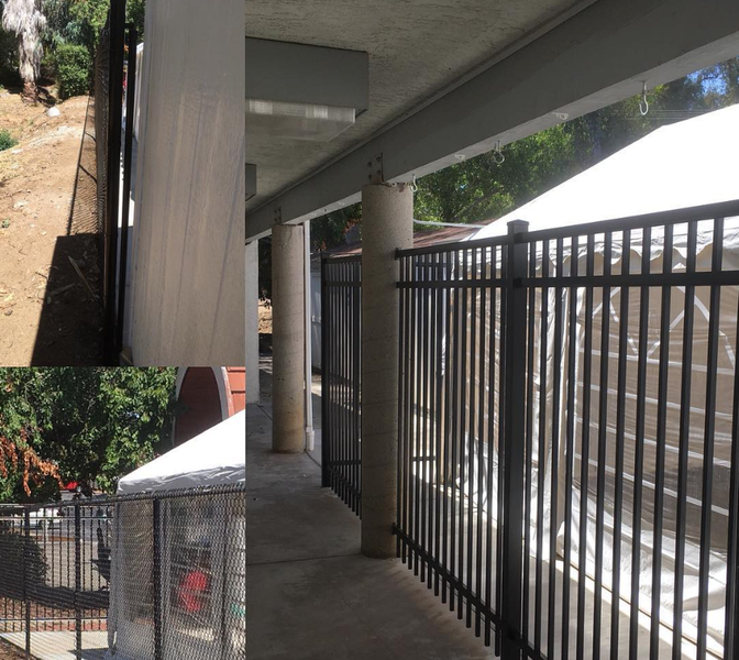 A fence with a white tent in the background