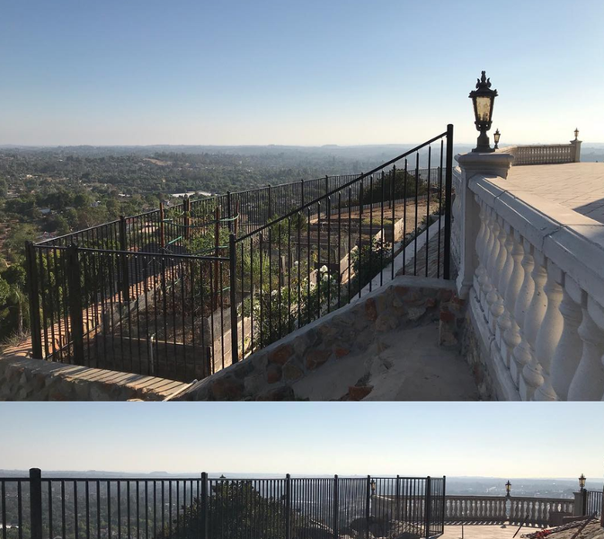 A fence with a view of a city and the ocean