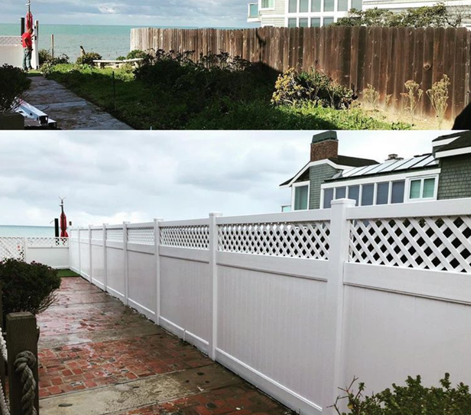 A white fence surrounds a walkway leading to the ocean.