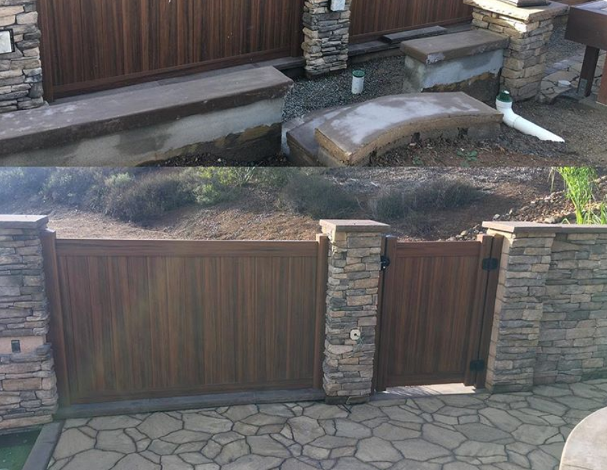 A wooden gate with a stone wall behind it