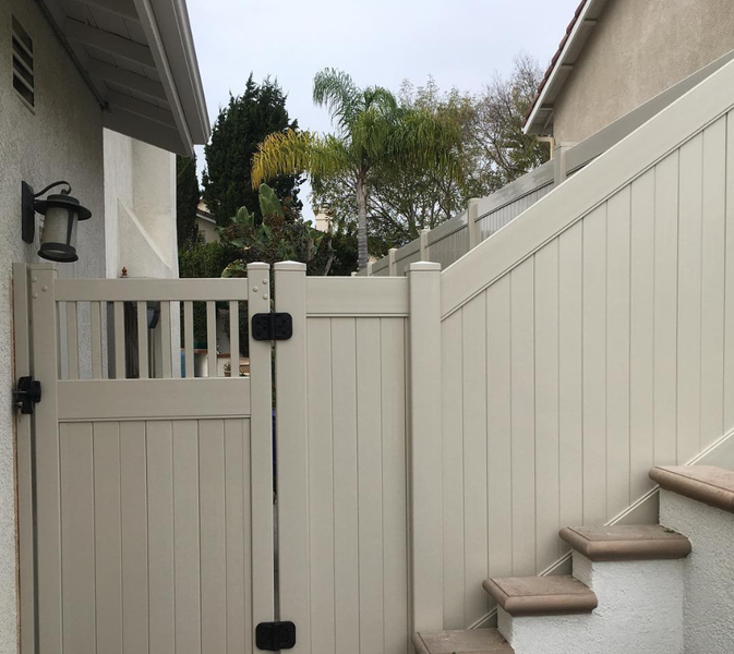 A white fence with stairs leading up to it