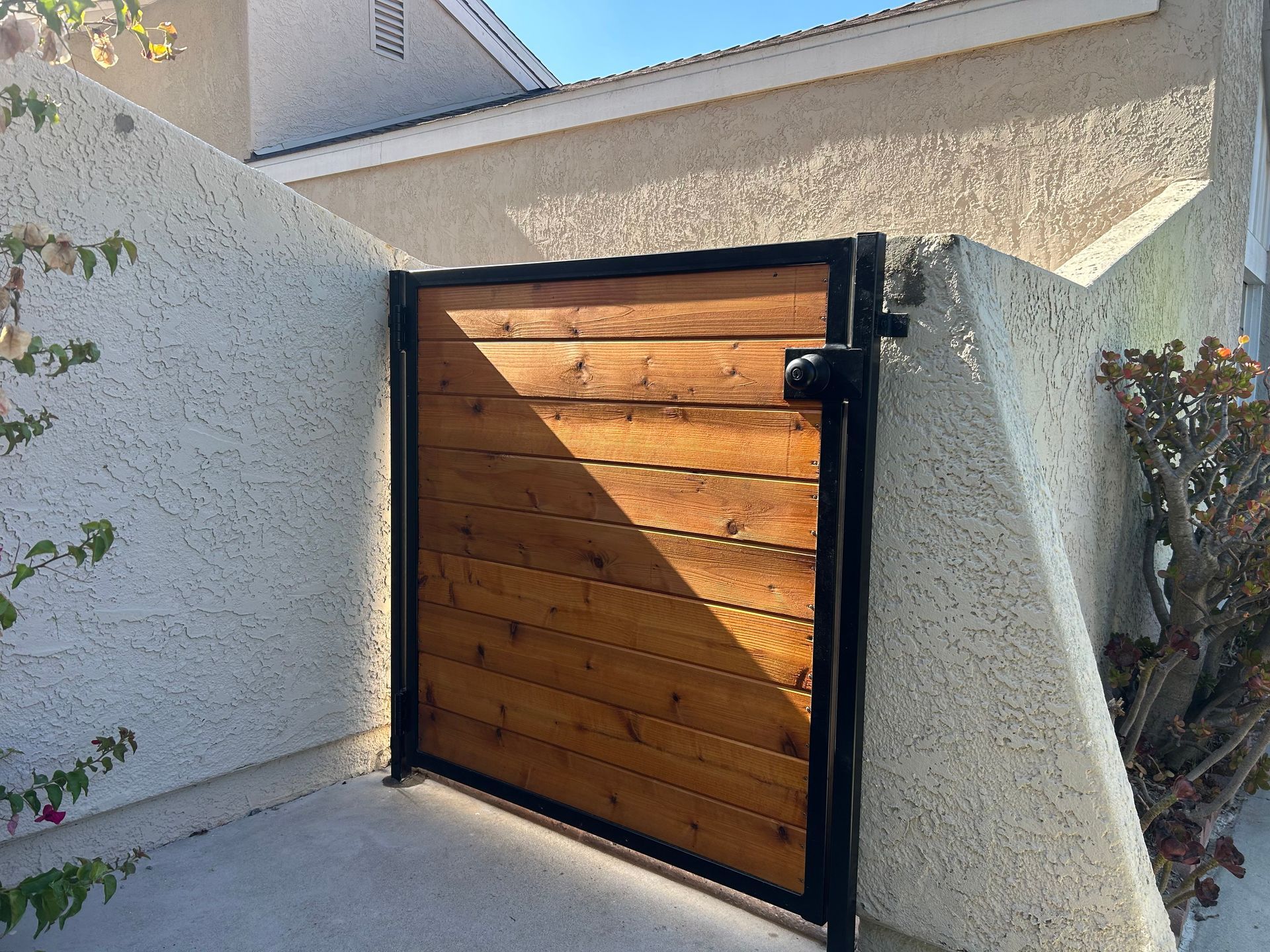 A wooden gate is sitting in front of a house.