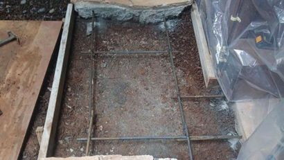 Concrete slab form with rebar grid and plastic sheeting during construction