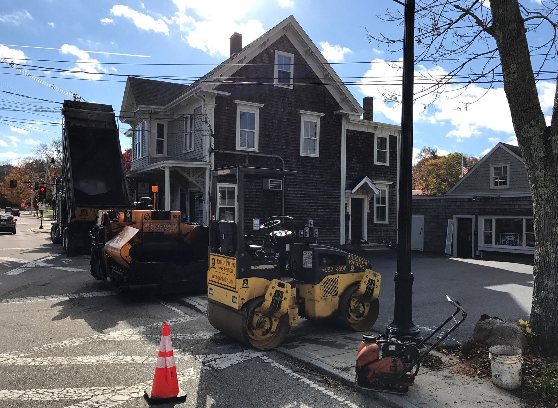 a dump truck is parked on the side of the road in front of a house