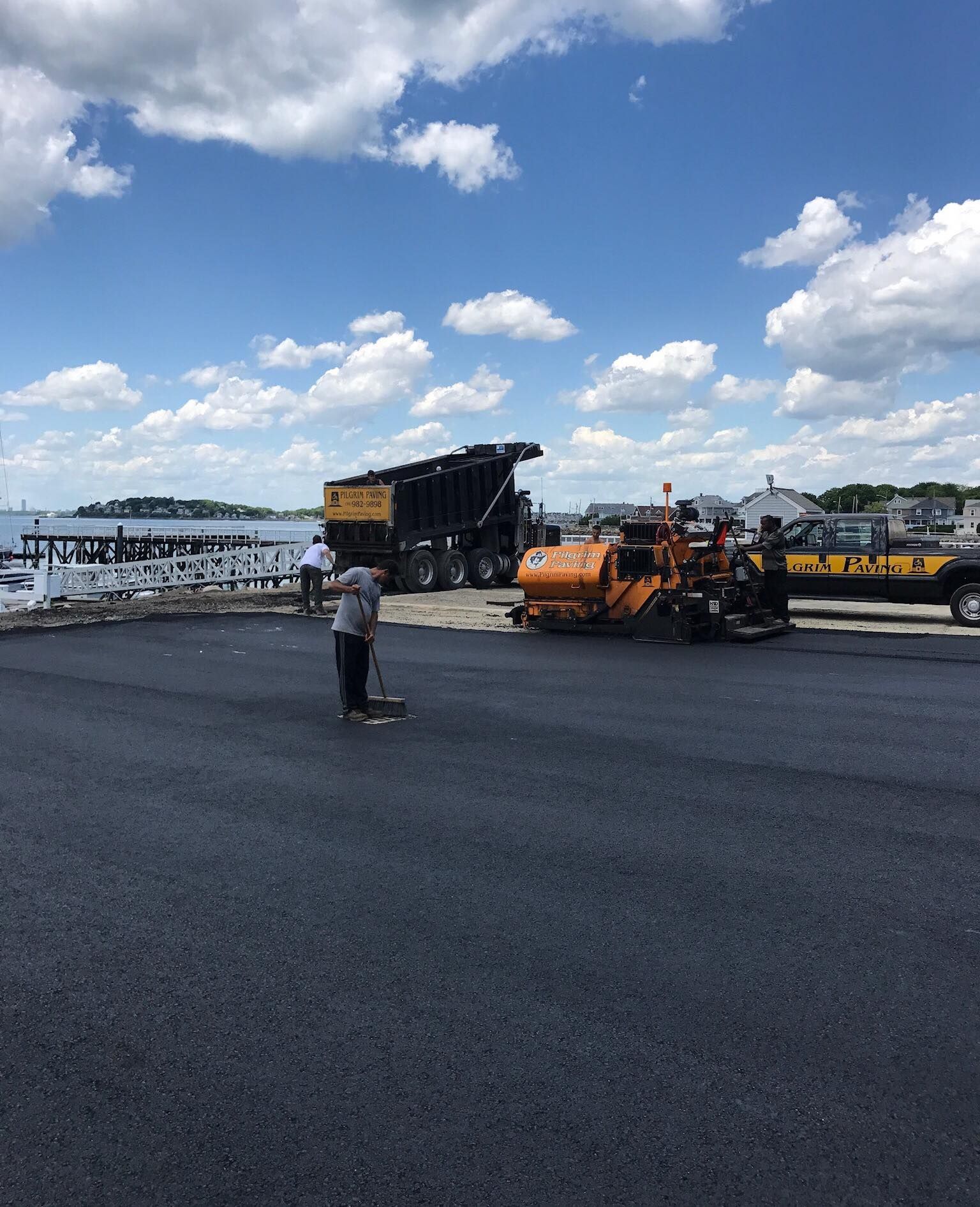 a man in a yellow shirt is working on a road