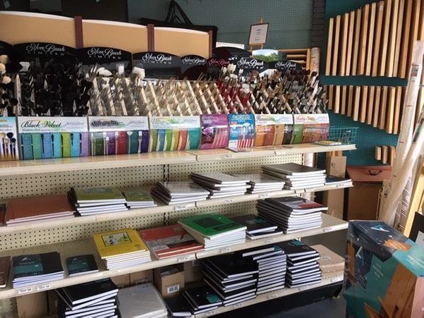 A store shelf filled with lots of books and pens