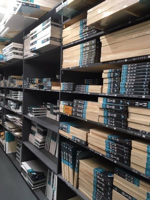 A library filled with lots of books and boxes