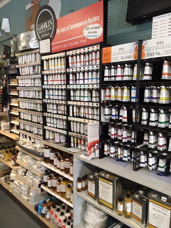 A store filled with lots of bottles of paint