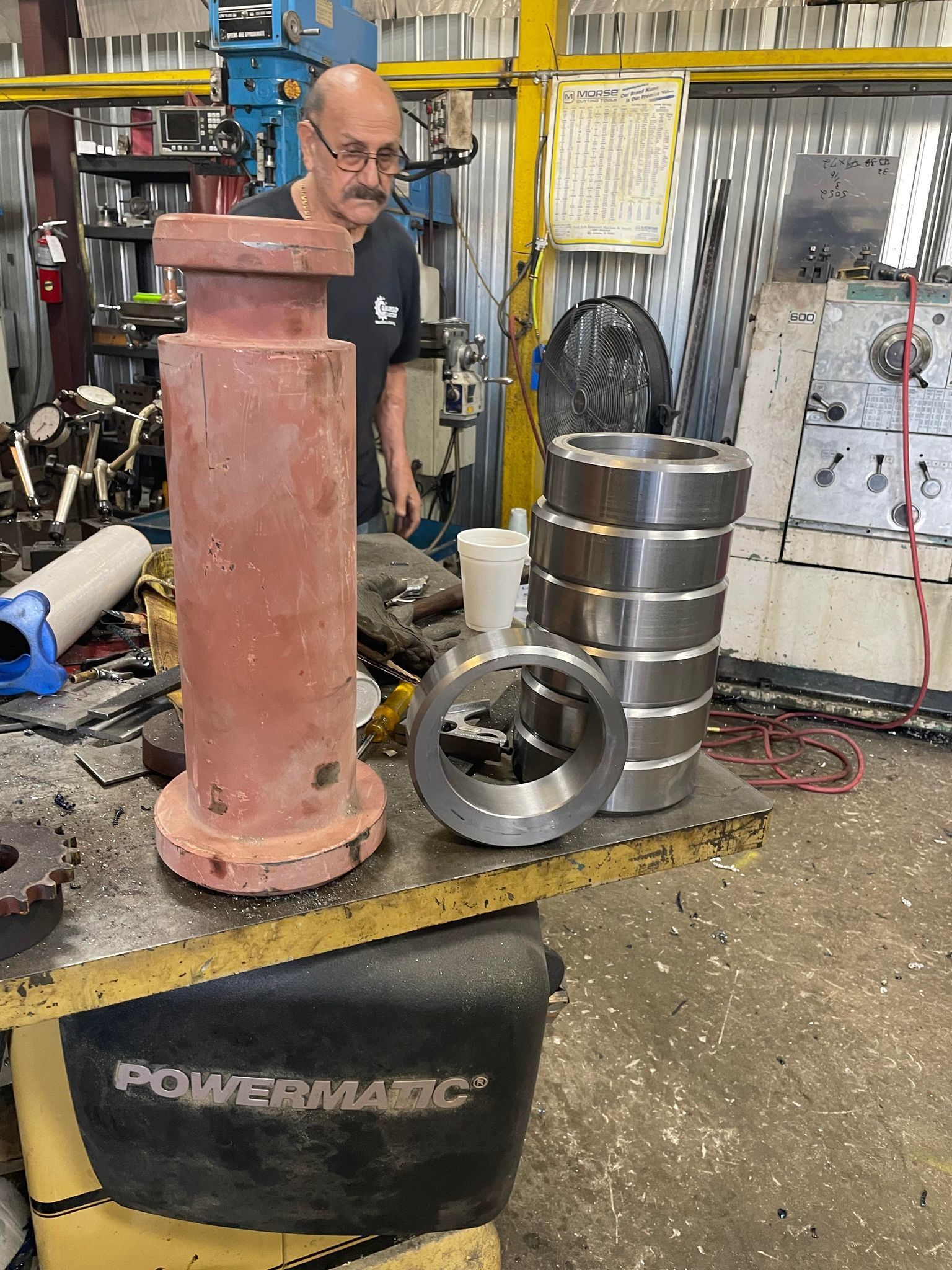 Man working on several metal parts