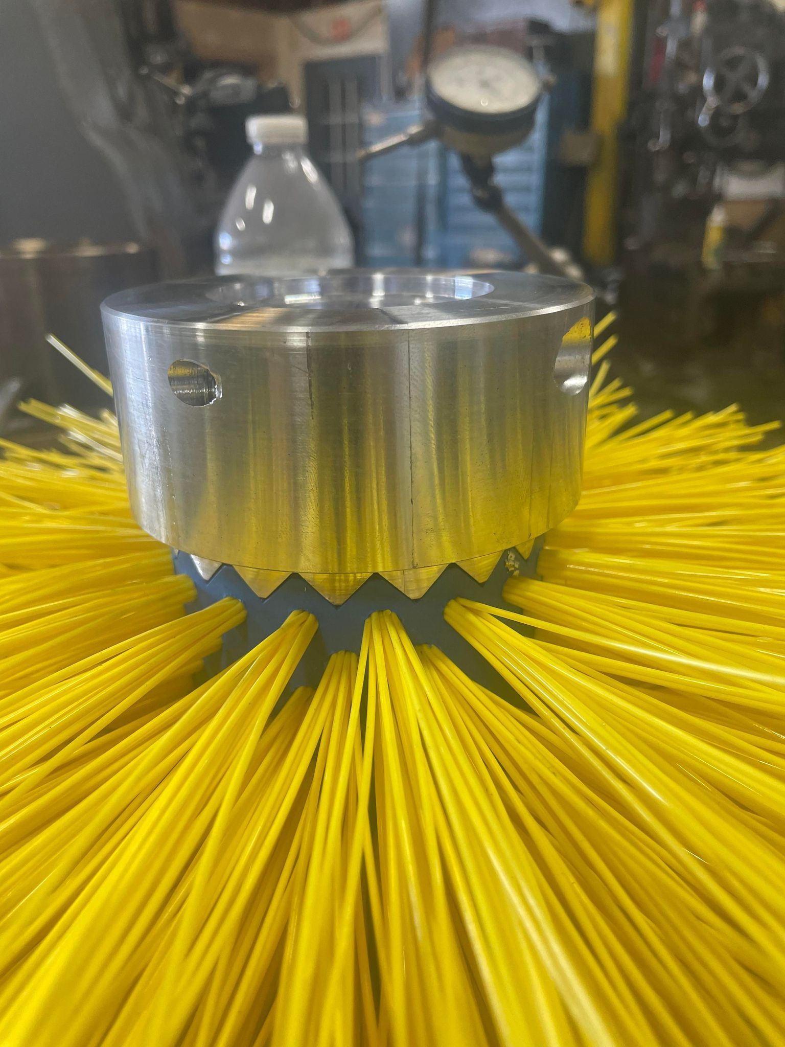 Metal part with ragged edges and yellow straws