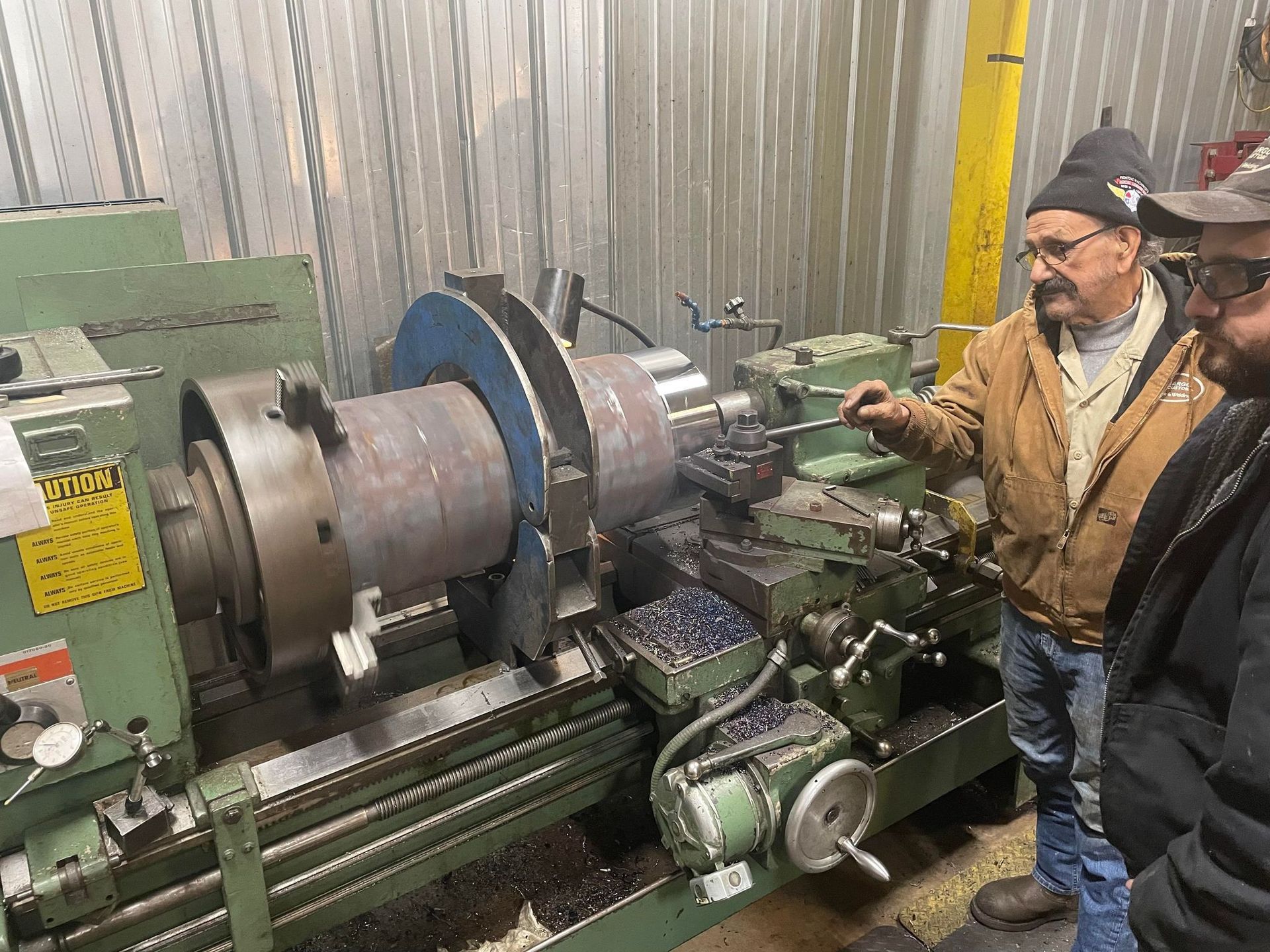 Two men inspecting a machine
