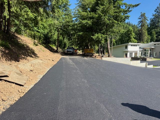 A car is parked on the side of a road next to a house