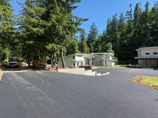 A large house with a large driveway in front of it