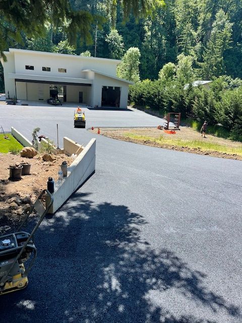 A large white building is being built in the woods