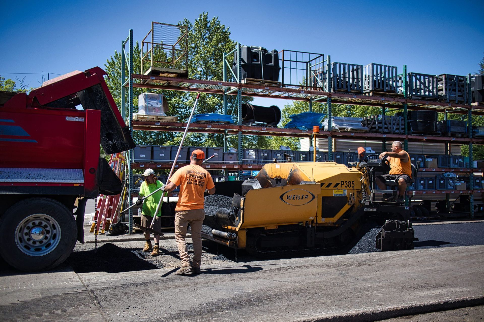 A group of construction workers are working on a road