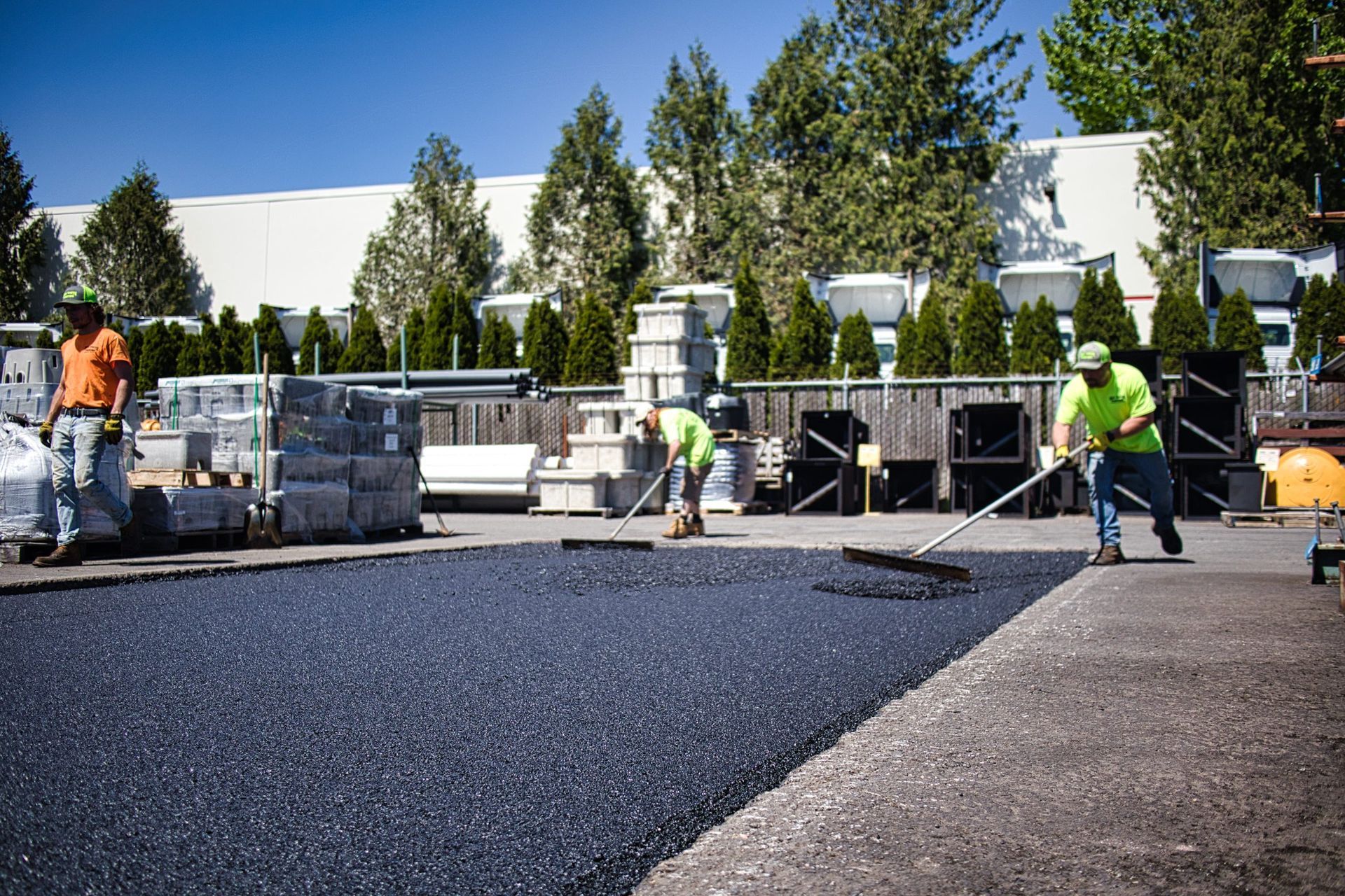 A group of construction workers are working on a road.