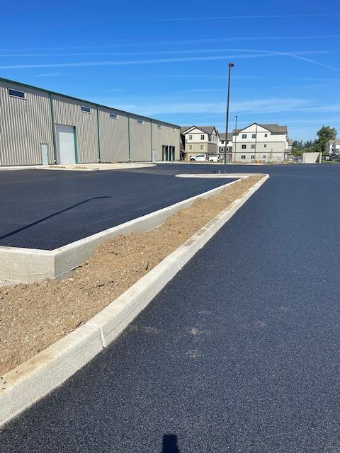 A parking lot with a building in the background