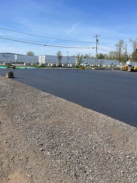 A road with a lot of gravel and a blue sky in the background