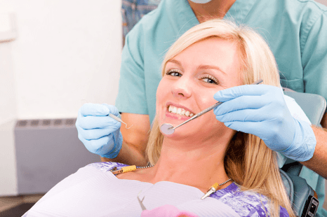 dentist examining boy's teeth