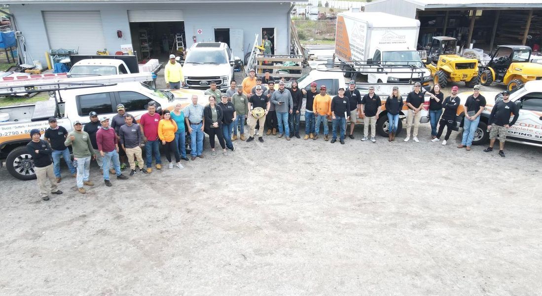 Group of people standing with vehicles outside a building.
