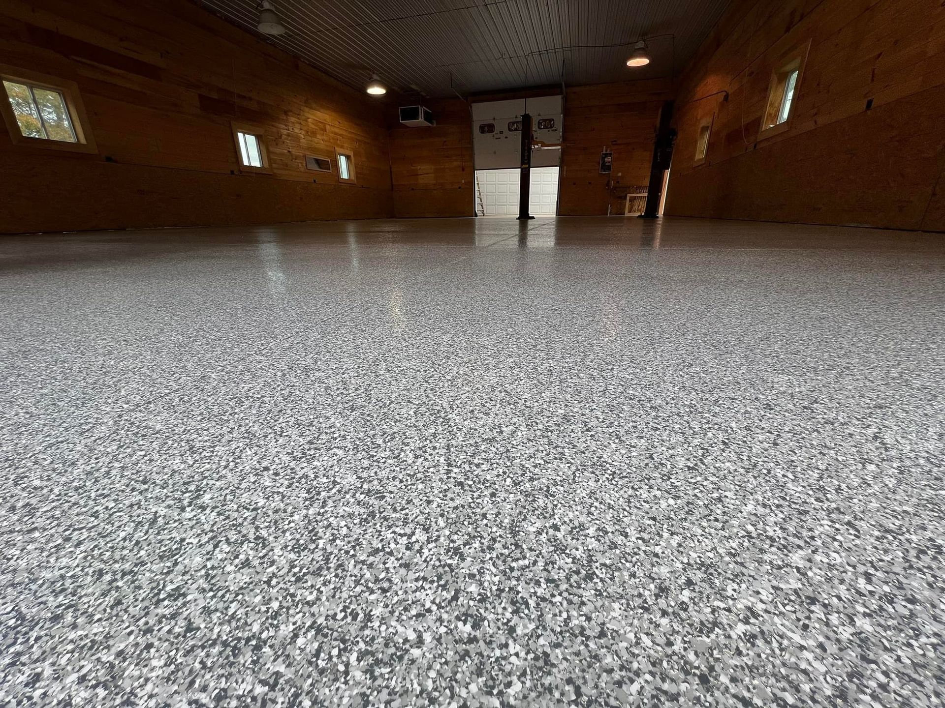 Gray speckled epoxy floor in a wooden interior.