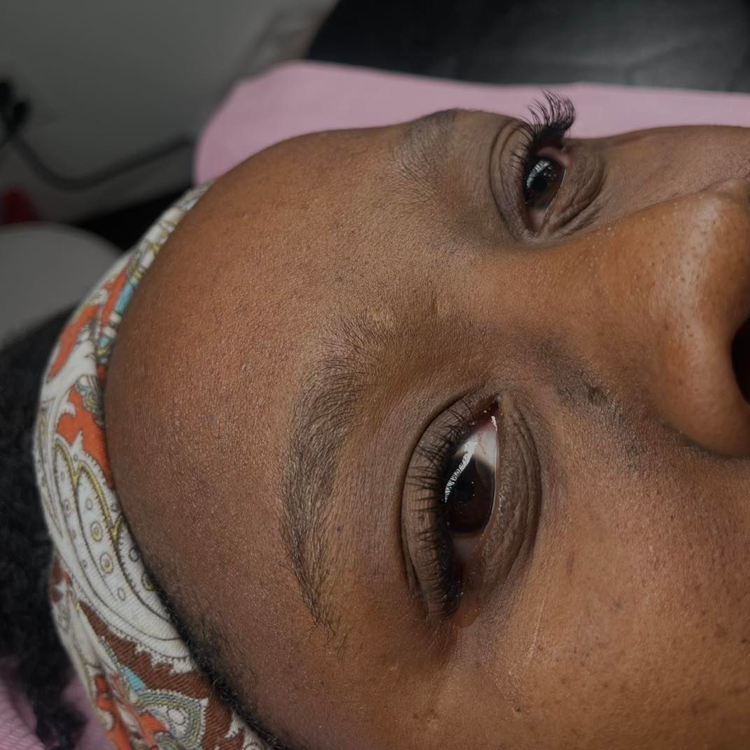 Close-up of a Black person's face, with eyebrows, eyes, and a head covering.