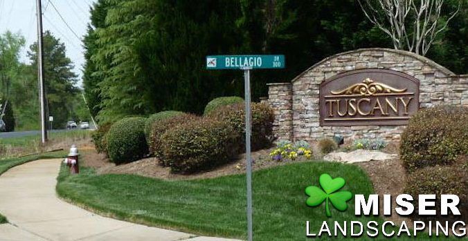 Sign for Tuscany neighborhood with landscaping and street sign for Bellagio.
