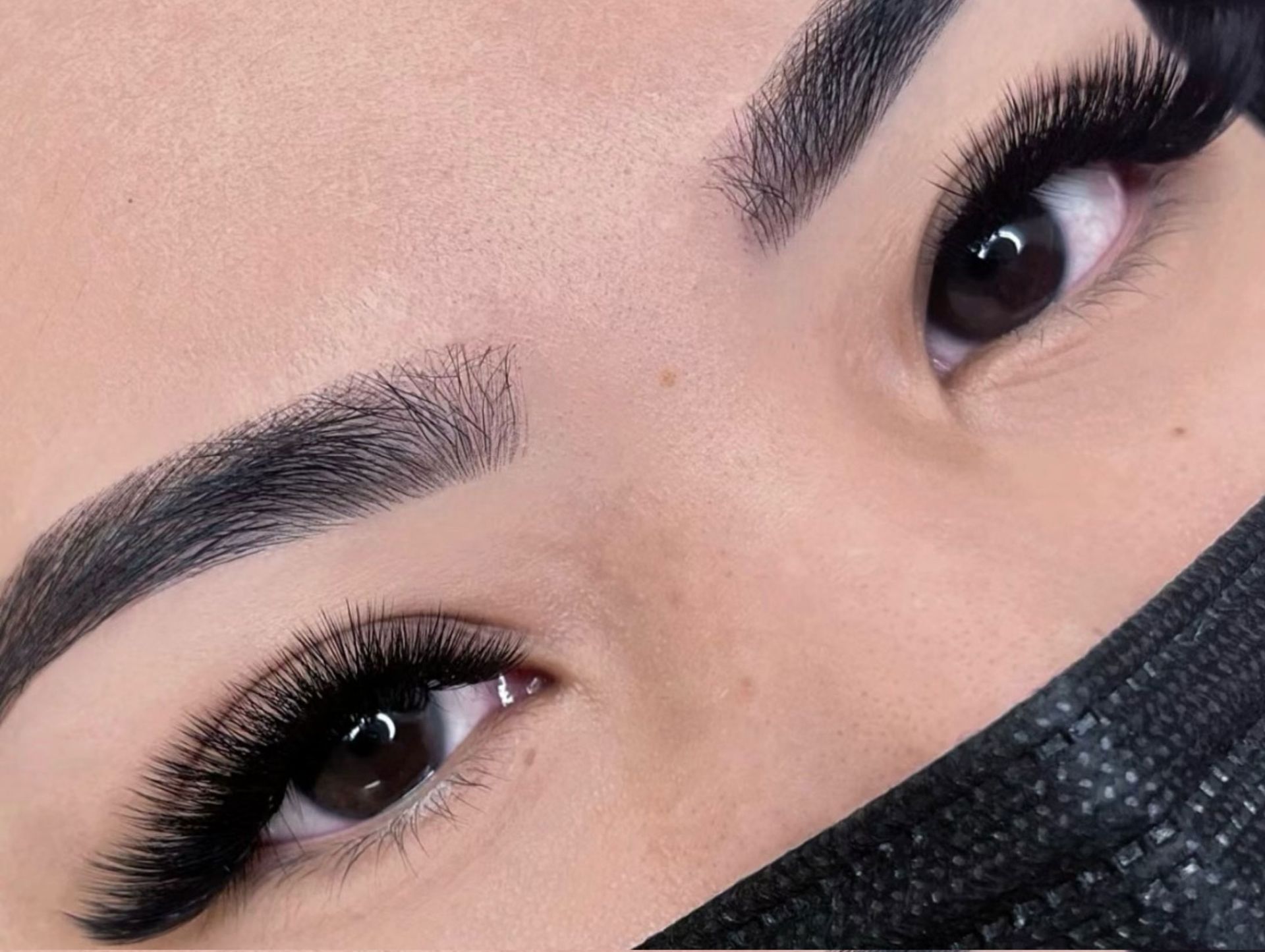 A close up of a woman 's eyes wearing a black mask.