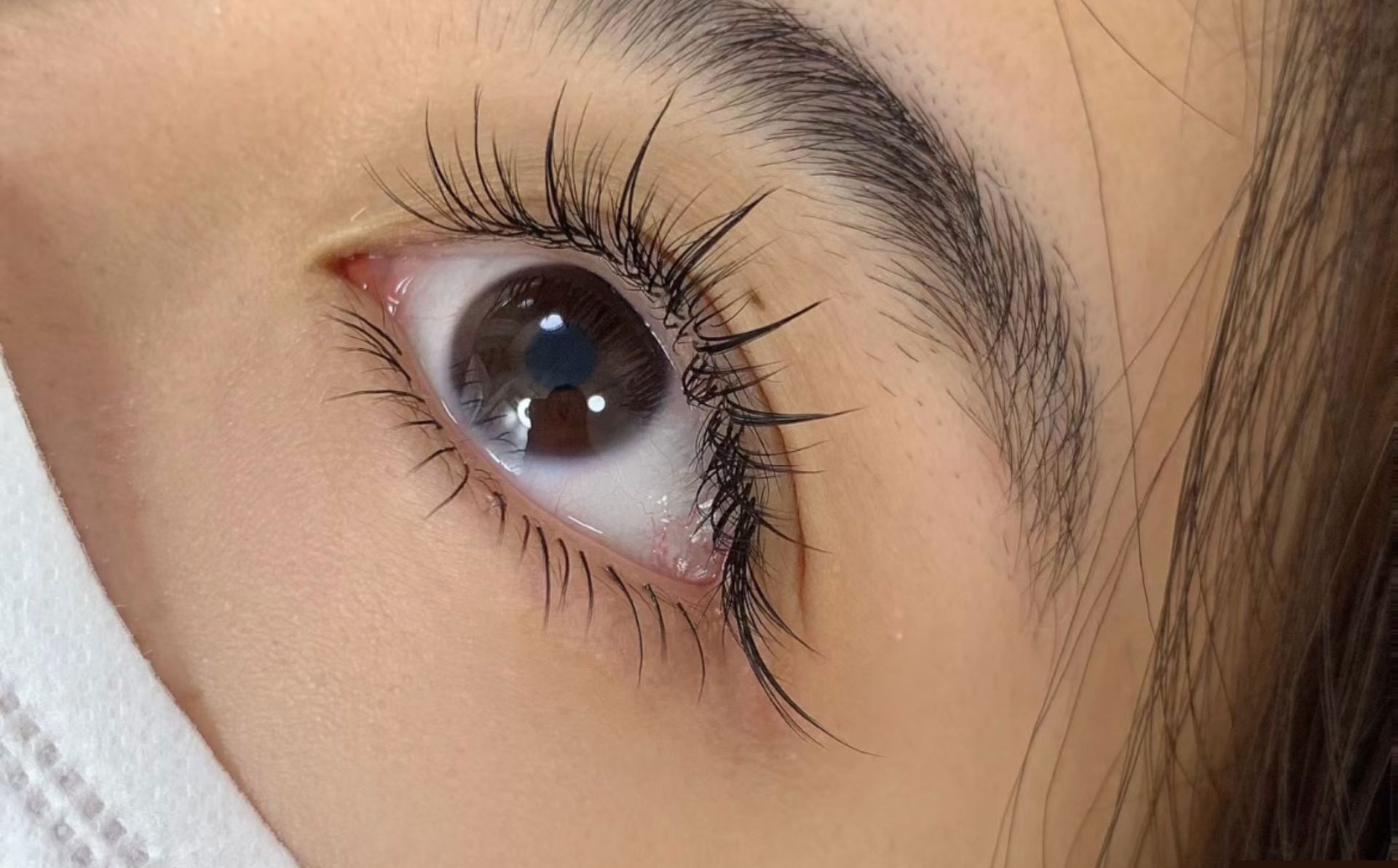 A close up of a woman 's eye with mascara on it.