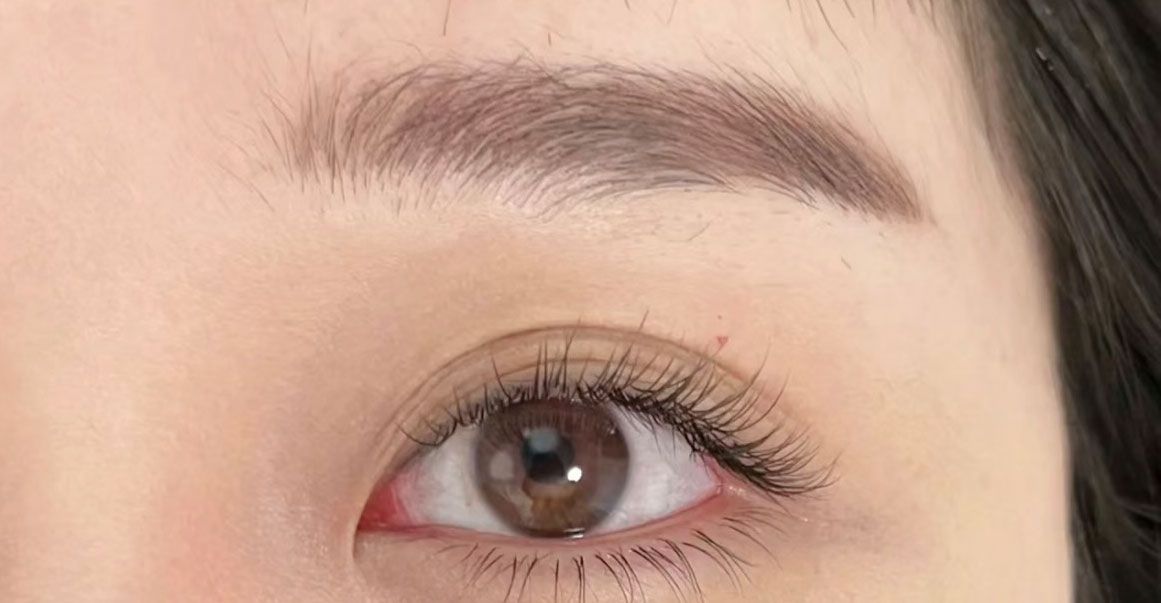 A close up of a woman 's eye with mascara on it.