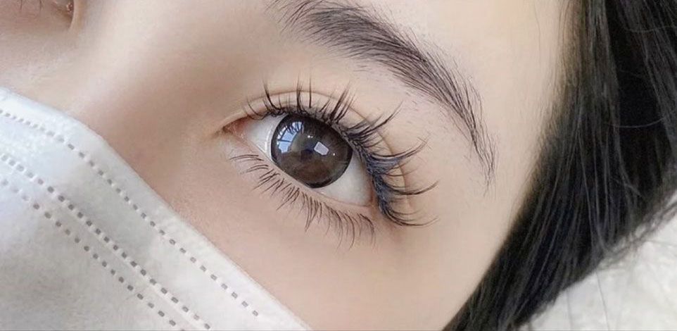 A close up of a woman 's eye wearing a mask.