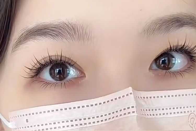 A close up of a woman wearing a face mask.