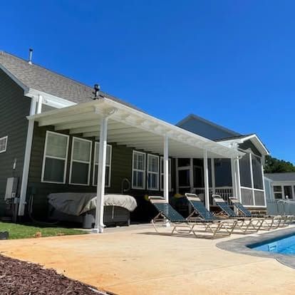 a house with a screened in porch and a swimming pool in front of it