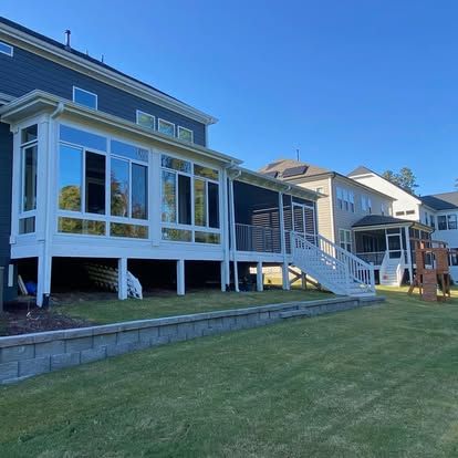 a large house with a large porch and stairs in the backyard