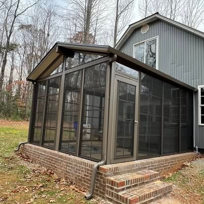 a screened in porch on the side of a house