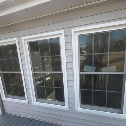 three windows on the side of a house