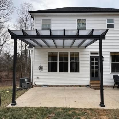 a white house with a pergola in front