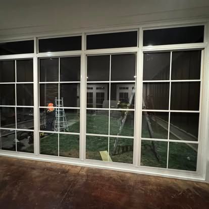 a room with a lot of windows and ladders