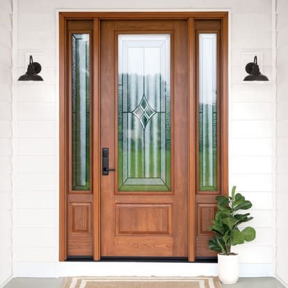 a wooden door with a plant in front of it on a porch