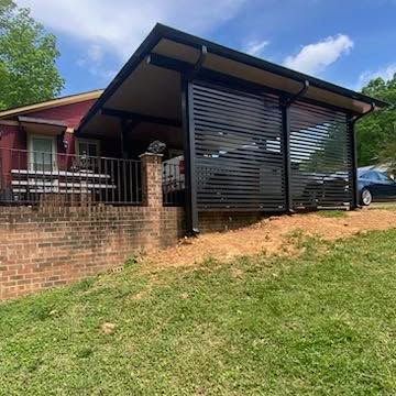 a house with a carport and a car parked in front of it