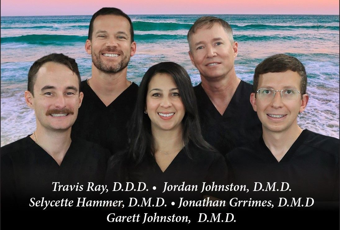 A group of doctors are posing for a picture and smiling